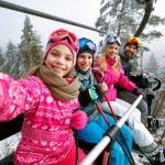 Skiing,,Ski,Lift,,Ski,Resort,-,Happy,Smiling,Family,Skiers