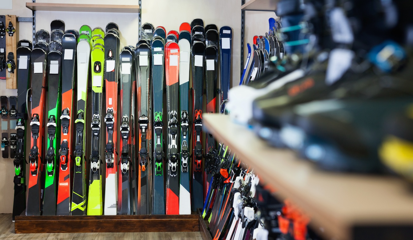 Variety of alpine skis for sale in modern sports equipment store